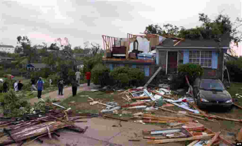 Homeowners survey damage after a tornado hits Pratt City just north of downtown Birmingham on Wednesday, April 27, 2011, in Birmingham, Ala. The widespread destruction caused Gov. Robert Bentley to declare a state of emergency by midday, saying tornadoe