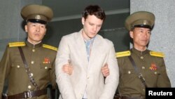 Otto Frederick Warmbier (C), a University of Virginia student who was detained in North Korea since early January, is taken to North Korea's top court in Pyongyang, North Korea, in this photo released by Kyodo March 16, 2016.