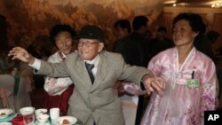 South Korean Yoo Youn-shick, 92, center, dances as his North Korean nieces stand by in a dinner during the Separated Family Reunion Meeting at Diamond Mountain resort in North Korea, Thursday, Feb. 20, 2014.