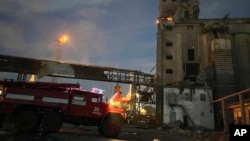 FILE - In this photo provided by regional Governor Oleh Kiper rescuers work on a scene of drone attack in Odesa region, Ukraine, early Aug. 2, 2023. Kiper said more drones hit port infrastructure in Odesa overnight Dec. 6. 