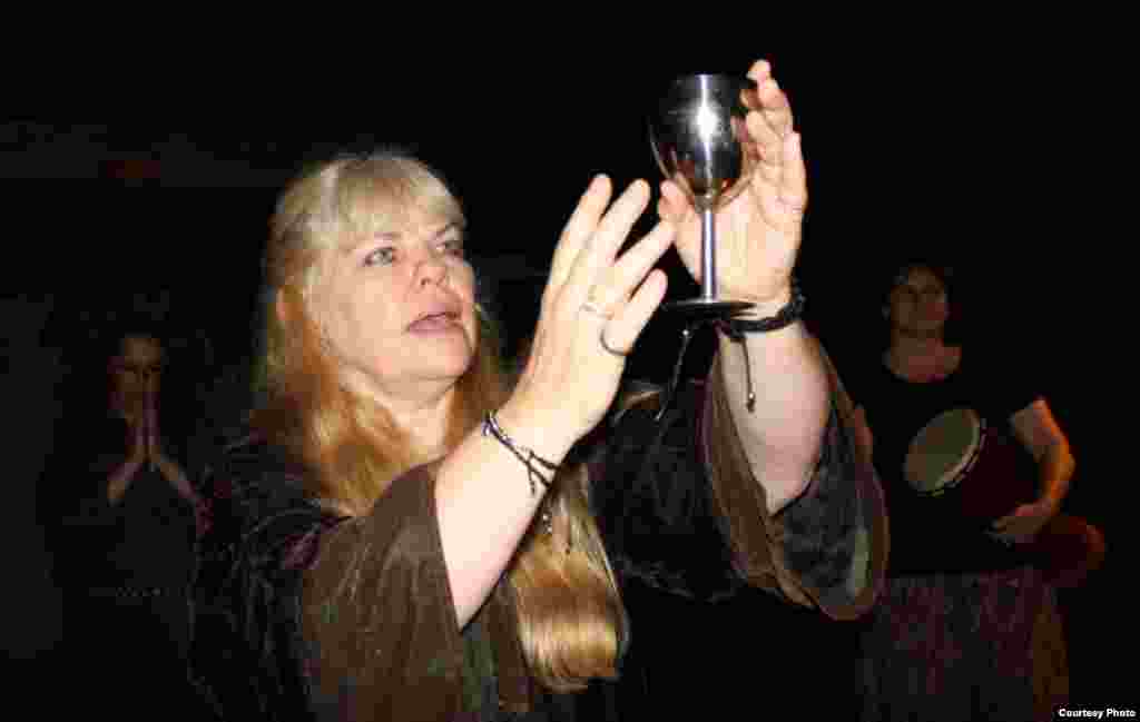 Pearson lifts a ceremonial goblet of wine. “We believe very strongly in Jesus; he’s the god of little children in paganism. We also believe very strongly in Mary, because she’s a virgin goddess…” (Photo by Darren Taylor)