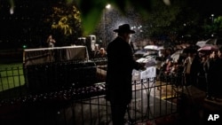 A rabbi delivers a eulogy next to the coffin containing the remains of Israeli-Moldovan rabbi Zvi Kogan in Kfar Chabad, Israel, Nov. 25, 2024. Kogan, 28, an ultra-Orthodox rabbi, was killed last week in Dubai where he ran a kosher grocery store. 