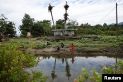 Anak-anak memancing di depan reruntuhan Masjid An Nur di Lhok Seudu, di pinggiran Banda Aceh, 22 Desember 2024. (Willy Kurniawan/REUTERS)