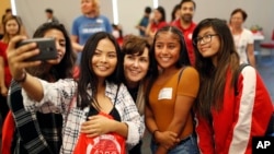 FILE - Rep. Jacky Rosen, D-Nev., center, poses for a selfie with high school students at an event put on by the Asian Community Development Council in Las Vegas, Sept. 29, 2018. 