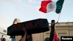 A protester holds a symbolic coffin reading 'democracy,' Sept. 1, 2012. 