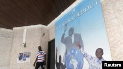 Un homme devant une affiche montrant l'ancien président ivoirien Laurent Gbagbo,au siège du FPI à Abidjan, le 2 septembre 2015 (Reuters)