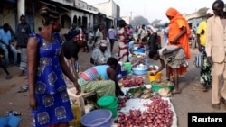 South Sudanese civilians conduct business at the market in Yei, southwest of the capital Juba, Jan. 1, 2017.