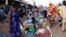 South Sudanese civilians conduct business at the market in Yei, southwest of the capital Juba, Jan. 1, 2017.