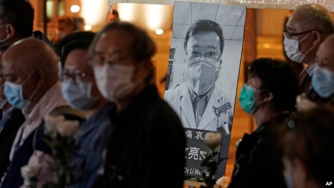香港民众戴着口罩为李文亮医生举行烛光守夜纪念仪式。(2020年2月7日) 