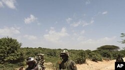 Ugandan peacekeepers from the African Union Mission in Somalia (AMISOM) patrol a road following an encounter with Islamist militia in the northern suburbs of Somalia's capital Mogadishu, January 20, 2012.