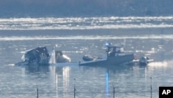 Search and rescue efforts are seen around a wreckage site in the Potomac River near Ronald Reagan Washington National Airport in Arlington, Virginia, early on Jan. 30, 2025.