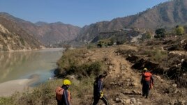 Rescuers arrive to search for bodies in the downstream of Alaknanda River in Rudraprayag, northern state of Uttarakhand, India, Monday, Feb.8, 2021.