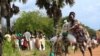 FILE - A refugee from South Sudan transports food she received from the World Food Program (WFP) in Palorinya settlement camp for distribution, in Moyo district northern Uganda.