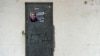 FILE - A poster is pasted on a door calling for the release of one of the most influential leaders of former Basque separatist group ETA, Josu Ternera, in the Spanish Basque village of Miraballes, May 16, 2019, after he was arrested in France. 