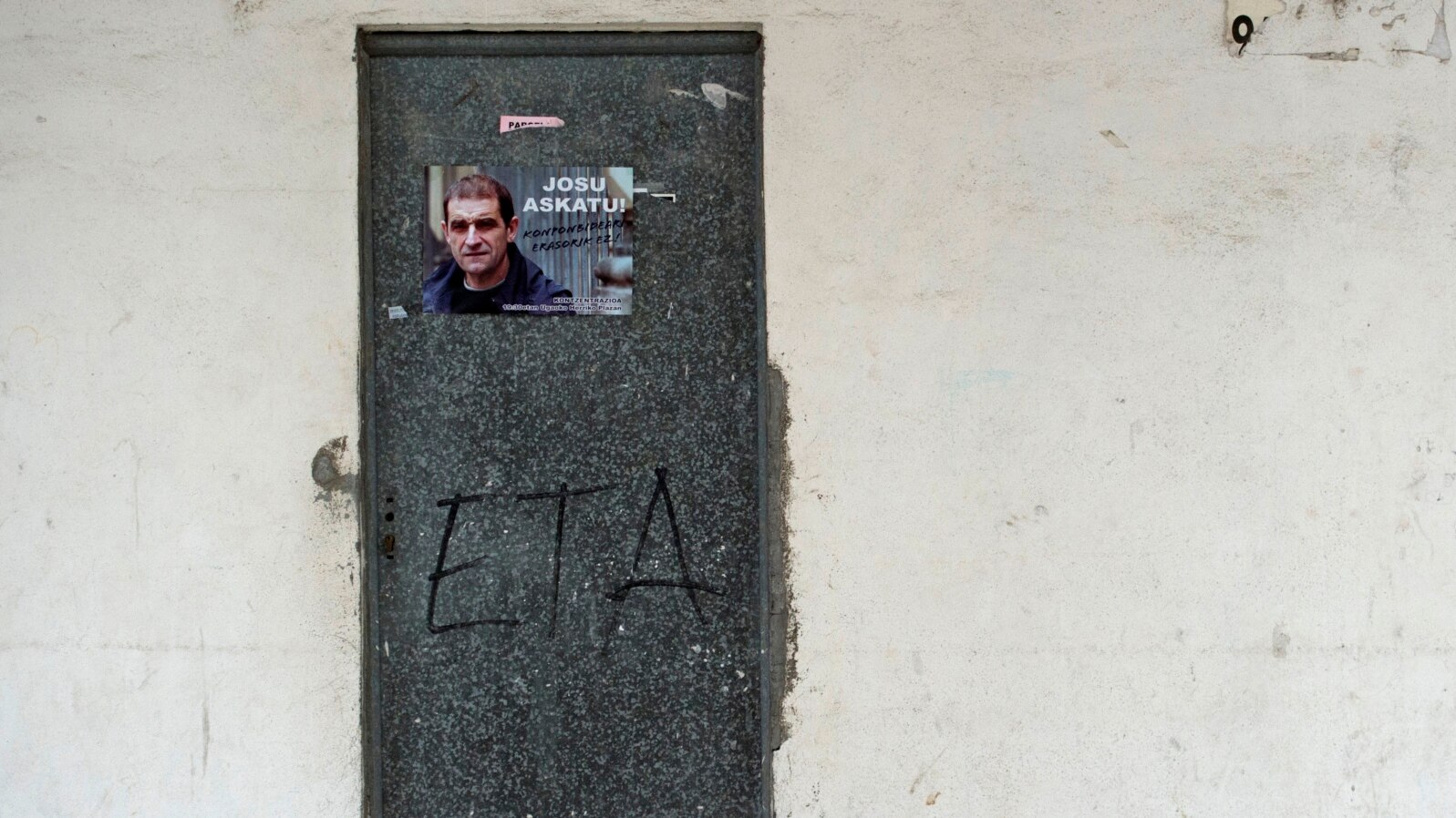 FILE - A poster is pasted on a door calling for the release of one of the most influential leaders of former Basque separatist group ETA, Josu Ternera, in the Spanish Basque village of Miraballes, May 16, 2019, after he was arrested in France. 