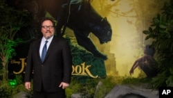Director Jon Favreau poses for photographers upon arrival at the European premiere of the film "The Jungle Book" in London, April 13, 2016. 