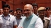 FILE - India's newly appointed Home Minister Amit Shah greets the media upon his arrival at the home ministry in New Delhi, India, June 1, 2019.