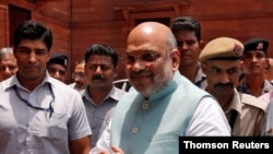 FILE - India's newly appointed Home Minister Amit Shah greets the media upon his arrival at the home ministry in New Delhi, India, June 1, 2019.