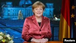 German Chancellor Angela Merkel concludes the recording of her New Year's speech in the Chancellery in Berlin, Dec. 30, 2014.