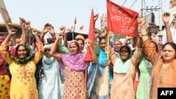 Women activists shout slogans on the occasion of International Women's Day as they demonstrate against India's recent agricultural reforms, in Amritsar on March 8, 2021.
