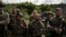 Ukrainian volunteers for the army listen to their commander after a training on the outskirts of Kyiv, Ukraine, Thursday, Aug. 10, 2023.