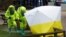 FILE - The forensic tent, covering the bench where Sergei Skripal and his daughter Yulia were found, is repositioned by officials in protective suits in the center of Salisbury, Britain, March 8, 2018.