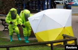 FILE - A forensic tent covering the bench where Russian double agent Sergei Skripal and his daughter Yulia were found poisoned is seen in Salisbury, Britain, March 8, 2018. The Kremlin is widely believed to have been behind the poisoning.