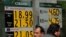 People walk past a board displaying the exchange rate for Mexican peso against the U.S. dollar and the euro in a Bank in Mexico City, Mexico, Nov. 15, 2016. 