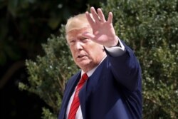 President Donald Trump gestures toward reporters on the South Lawn of the White House in Washington, Sept. 26, 2019, after returning from the U.N. General Assembly in New York.