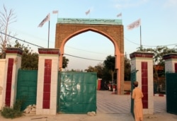 Taliban flags fly on the gate of Ghazni provincial governor's house, in Ghazni, southeastern, Afghanistan, Aug. 15, 2021.