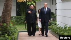 North Korea's leader Kim Jong Un and U.S. President Donald Trump talk in the garden of the Metropole hotel during the second North Korea-U.S. summit in Hanoi, Vietnam, Feb. 28, 2019.