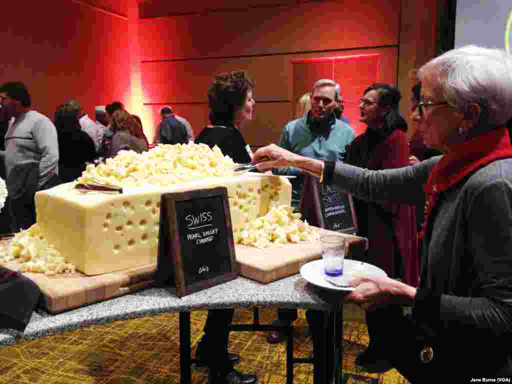 Guests at the U.S. Cheese Championship gala could help themselves to samples from a giant wheel of Swiss cheese that had been among the cheeses judged in the competition, in Green Bay, Wis., March 7, 2019.