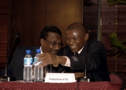 FILE - Then-Acting Special Representative of the U.N. Secretary General for Burundi, Nureldin Satti, left, talks with Burundi politician Agathon Rwasa during the Plenary Session on Burundi negotiations in Dar es Salaam, May 29, 2006.