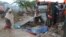 FILE - Members of a family stand next to their makeshift house that was swept at the internally displaced people (IDP) camp in Hodon district in Mogadishu, Somalia, May 30, 2015, following heavy rain that has pounded the parts of the country. United Nations predicts that up to 900,000 people could be hit by the strongest El Niño weather phenomenon in decades.