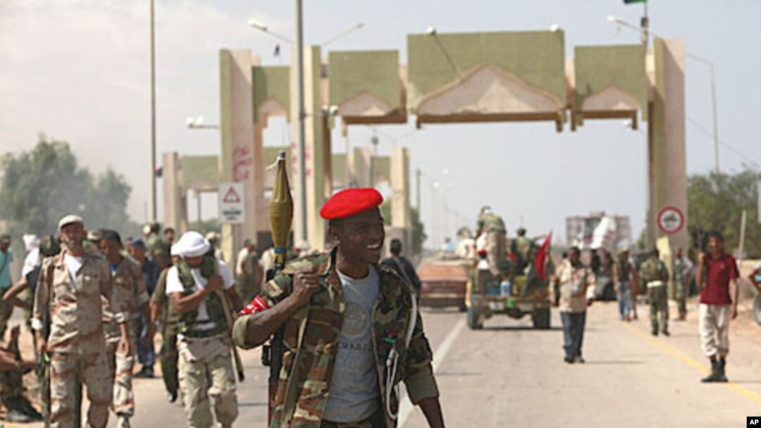 Anti-Gaddafi fighters stand guard after they took over El-Khamseen gate, the eastern gate of Sirte, Libya, September 24, 2011.