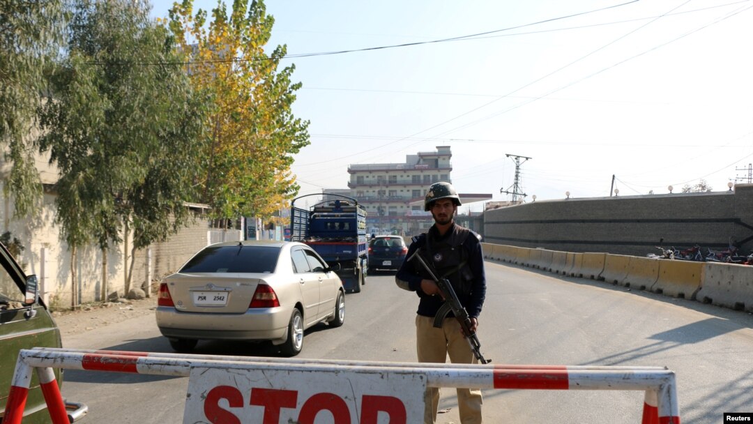 FILE - A policeman stands guard on a road in Mingora, in Swat Valley, Pakistan, Dec. 4, 2016. Saturday, a suicide bombing targeted army officials in a part of the scenic valley where members of the military conduct sports activities.