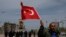 A supporter of Turkey's main opposition Republican People's Party, CHP, waves a national flag as people gather for a sit-in protest in central Istanbul's Taksim Square, Monday, April 16, 2018.