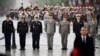 FILE - French generals and admirals stand guard behind French President (front right) at the tomb of the unknown soldier under the Arc de Triomphe landmark on top of the Champs Elysees avenue on May 8, 2019 in Paris. 