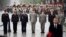 FILE - French generals and admirals stand guard behind French President (front right) at the tomb of the unknown soldier under the Arc de Triomphe landmark on top of the Champs Elysees avenue on May 8, 2019 in Paris. 