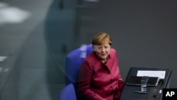 German Chancellor Angela Merkel attends a debate about German government's policies to combat the spread of the coronavirus and COVID-19 disease at the parliament Bundestag, in Berlin, Germany, Oct. 29, 2020. 