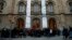 People wait for the opening of a polling station to cast their vote for the Catalan regional election in Barcelona, Spain, Dec. 21, 2017. 