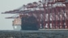 FILE - Gantry cranes stand near a cargo ship at Yangshan Port outside of Shanghai, Feb. 7, 2025. 