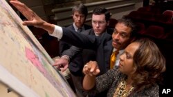 FILE - Lawmakers study a map of the proposed redistricting plan following a meeting of the Legislative Committee on Reapportionment at the Alabama Statehouse in Montgomery, Ala., May 9, 2012. The state's legislature approved new, court-ordered election m