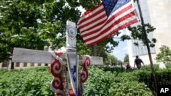 A makeshift memorial to slain Massachusetts Institute of Technology police officer Sean Collier is surrounded by foliage on the campus of MIT, July 23, 2014, in Cambridge, Massachusetts. Stephen Silva was the owner of the gun that killed Collier.