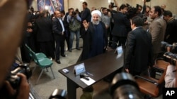 Iranian President Hassan Rouhani waves to the media as he arrives at the Interior Ministry to register his candidacy for the May 19 presidential elections, in Tehran, April 14, 2017