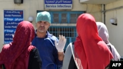 A doctor gestures outside a hospital in the Algerian town of Boufarik, as the country faces a cholera outbreak, Aug. 28, 2018.