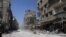 In this photo taken during a Syrian government-led media tour, buildings damaged during battles between Syrian troops and rebels stand along an empty street in Mleiha, about 10 kilometers (6 miles) southeast of downtown Damascus, Syria, Aug. 15, 2014. 