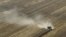 In this Aug. 16, 2012 file photo, dust is blown from behind a combine harvesting corn in a field near Coy, Ark. 