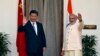 India's Prime Minister Narendra Modi, right, and China's President Xi Jinping wave to the media during a photo opportunity ahead of their meeting at Hyderabad House in New Delhi, Sept. 18, 2014. 