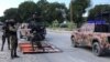 Haiti's National Police guard remove makeshift barricades made of steel fences and tree branches protesters placed to block the National Palace entrance, Oct. 31, 2019. (Photo: Matiado Vilme / VOA) 